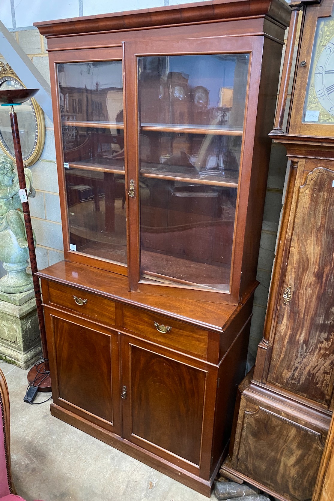 A late Victorian mahogany bookcase cupboard, width 108cm, depth 52cm, height 215cm